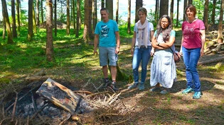 Brandstiftungen: Revierförster Reto Bless und die Leiterinnen der Waldspielgruppe Kaltbrunn begutachten Schäden.