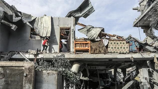 ARCHIV - Palästinenser inspizieren ein Haus, das nach einem israelischen Luftangriff zerstört wurde. Nach einem Angriff in Rafah erlag eine schwangere Frau ihren Verletzungen, ihr Baby konnte jedoch mit einem Kaiserschnitt gerettet werden - Nun ist es…