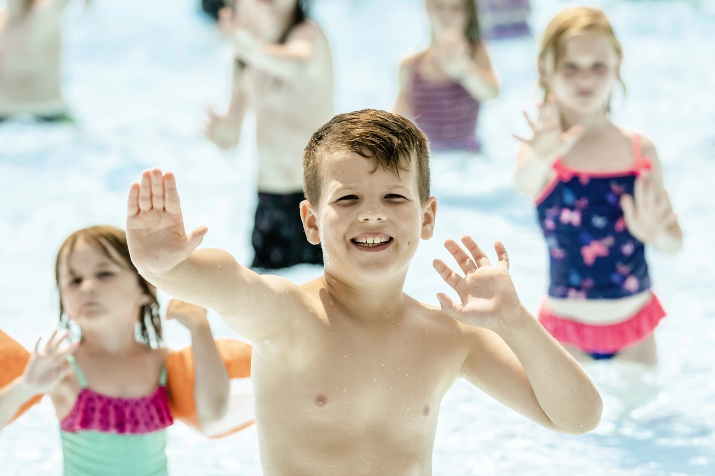 Im Wasser Tanzen: Begeistert bewegen sich die Kinder zu Musik und folgen den Vorgaben einer Betreuerin.