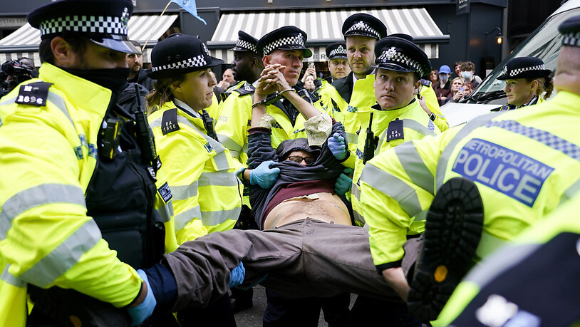 Polizisten verhaften einen Demonstranten, der sich während eines von der Umweltschutzbewegung Extinction Rebellion organisierten Protests unter einen Lieferwagen klebte. Bei der Protestaktion in London laut Mitteilung von Scotland Yard am späten…