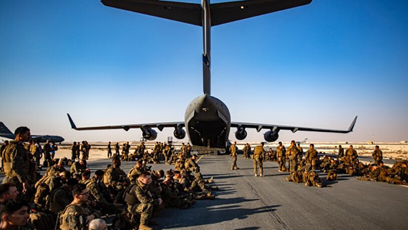 HANDOUT - US-Marines warten auf dem Luftwaffenstützpunkt Al Udeied in Katar auf ihren Flug nach Kabul. Nach Berichten über schlechte hygienische Zustände auf dem Militärflugplatz nahe der katarischen Hauptstadt Doha haben die USA schnelle Besserung…