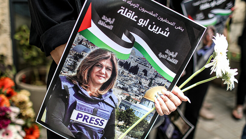 Ein Demonstrant hält ein Poster der Al-Dschasira-Reporterin Shireen Abu Akleh, um ihren Tod zu verurteilen. Foto: Ilia Yefimovich/dpa