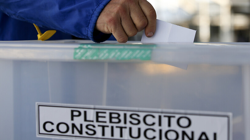 Ein Mann gibt seinen Stimmzettel in einem Wahllokal in Santiago. Foto: Luis Hidalgo/AP/dpa