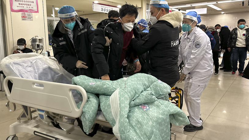 Ein Patient wird in der Notaufnahme eines Krankenhauses auf ein Bett gelegt. .China erlebt gerade eine riesige Corona-Welle, der besonders Menschen im hohen Alter oder mit Vorerkrankungen zum Opfer fallen. Krankenhäuser sind überlastet, Krematorien…
