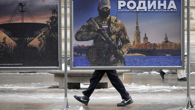 ARCHIV - «Wir verteidigen das Vaterland» steht auf diesem Plakat im russischen St. Petersburg. Foto: Dmitri Lovetsky/AP/dpa