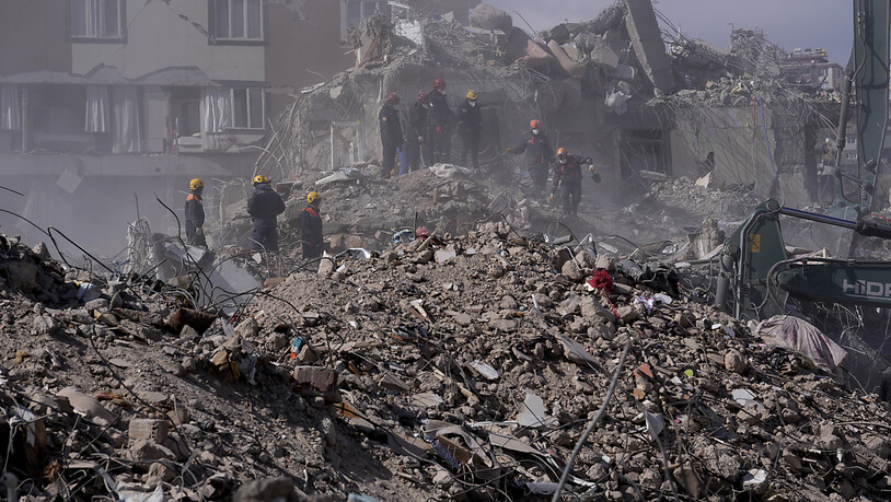 Rettungskräfte suchen in den Trümmern nach Überlebenden. Foto: Hussein Malla/AP/dpa