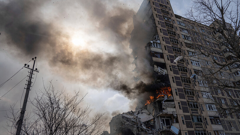 Ein Gebäude mit mehreren Geschäften brennt nach einem Luftangriff. Foto: Evgeniy Maloletka/AP