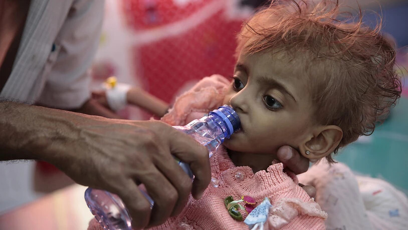 Ein Vater gibt seinem schwer unterernährten Töchterchen in einem Spital in Hodeida zu trinken. Im Hafen von Hodeida werden die meisten Importe und internationalen Hilfslieferungen für den Jemen umgeschlagen. Das Leben hunderttausender Kinder hängt davon…