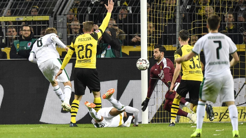 Christoph Kramer bezwingt kurz vor der Pause Dortmund-Goalie Roman Bürki zum 1:1-Ausgleich, während Lukasz Piszczek (Nummer 26) wegen eines Handspiels reklamiert.