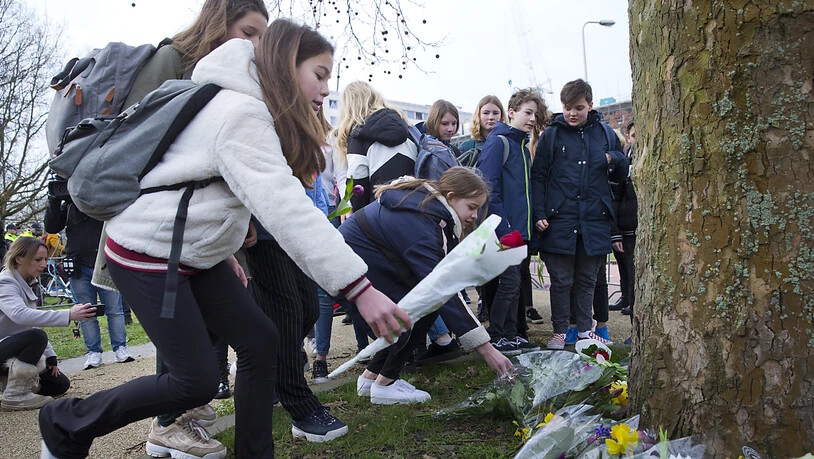 Schüler legen in Utrecht Blumen an dem Platz nieder, an dem am Montag in einer Strassenbahn drei Menschen erschossen und sieben verletzt worden waren.