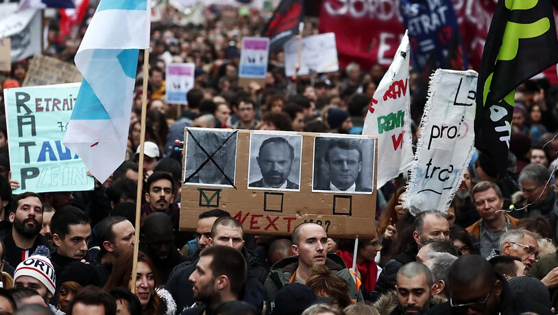 Demonstranten in Paris fordern den Rücktritt von Premierminister Edouard Philippe und Präsident Macron. Links auf dem Plakat ist Jean-Paul Delevoye abgebildet, der Rentenbeauftragte der Regierung trat am Montag nach Enthüllungen über zahlreiche Nebenjobs…