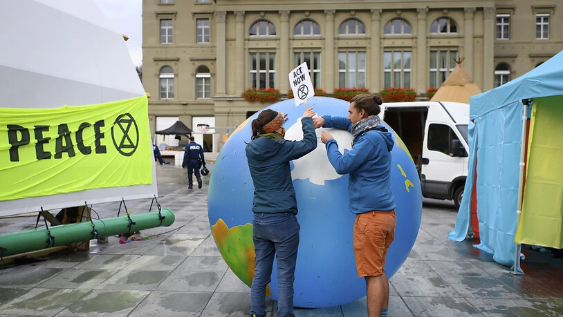 Zwei Klima-Aktivisten bei den Aufräumarbeiten auf dem Bundesplatz.