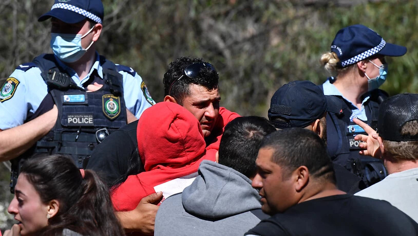 Anthony Elfalak, the father of 3 year old missing boy AJ Elfalak, hugs family and friends when they learn AJ has been found alive on the family property near Putty south west of Sydney, Monday, September 6, 2021. Three year old AJ  has been missing for 4…