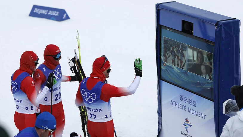Dario Cologna winkt im Ziel des auf 30 km verkürzten 50ers via Videoschaltung seiner Frau und seinem Sohn zu. Soeben ist das letzte Olympia-Rennen des Bündners über die Bühne gegangen