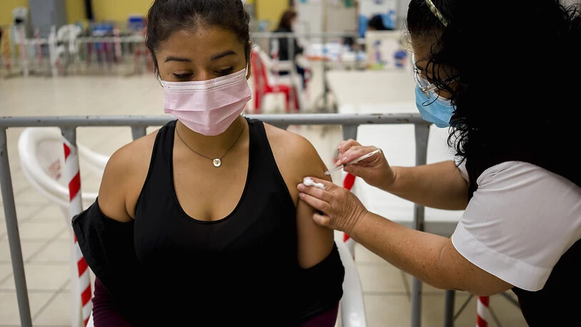Ein Mitarbeiter der Gesundheitsbehörde in Guatemala gibt einer Frau einen Covid-Booster mit dem Impfstoff AstraZeneca. In vielen Ländern nehmen die Corona-Infektionen wieder rapide zu. Eine internationale Allianz fordert die Freigabe von Covid-19…
