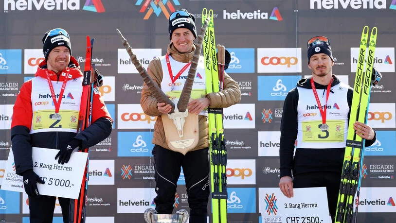 Sie waren die Schnellsten: Roman Furger, Dario Cologna und Tom Mancini strahlen auf dem Podium des Engadin Skimarathon um die Wette.
