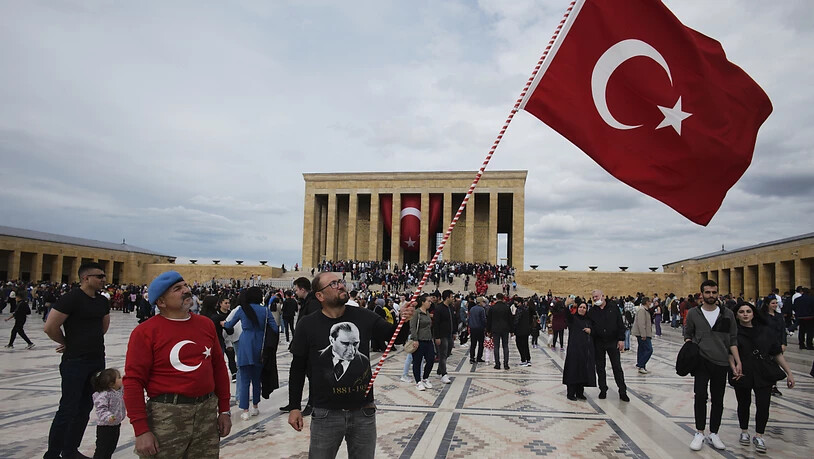 Ein Mann schwenkt eine türkische Nationalfahne, während Tausende das Mausoleum von Mustafa Kemal Atatürk besuchen. Die Vereinten Nationen verwenden auf Wunsch der Türkei ab sofort «Türkiye» anstelle der bisherigen englischen Landesbezeichnung «Turkey»…