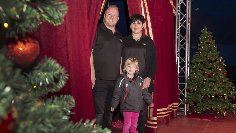 Der Circus Maramber hat am vergangenen Freitag mit der Weihnachtsshow gestartet. Das Gründerpaar Marco und Ramona Berger aus Domat/Ems posiert mit der fünfjährigen Tochter Juna vor dem Vohang. 
