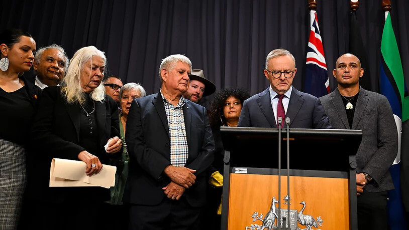 Australian Prime Minister Anthony Albanese surrounded by members of the First Nations Referendum Working Group speaks to the media during a press conference at Parliament House in Canberra, Thursday, March 23, 2023. (AAP Image/Lukas Coch) NO ARCHIVING