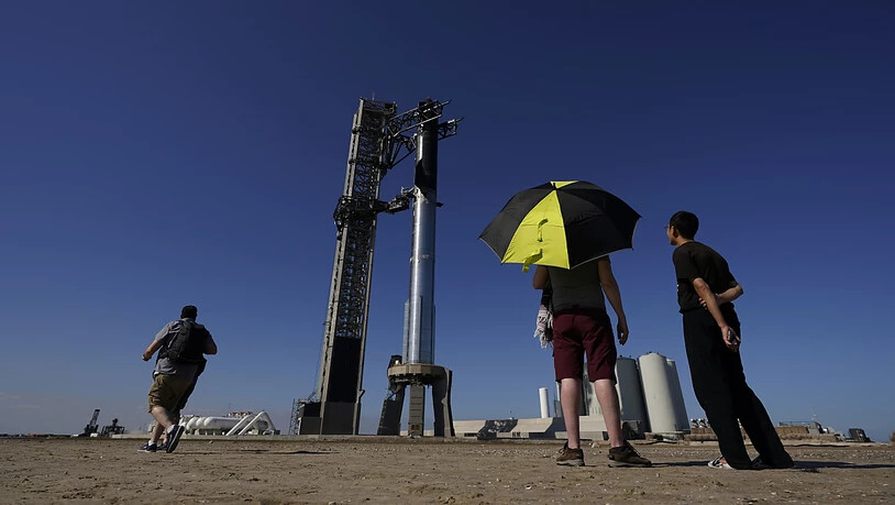 Schaulustige beobachten, wie die Rakete «Starship» von SpaceX für ihren bevorstehenden Start vorbereitet wird. Foto: Eric Gay/AP/dpa