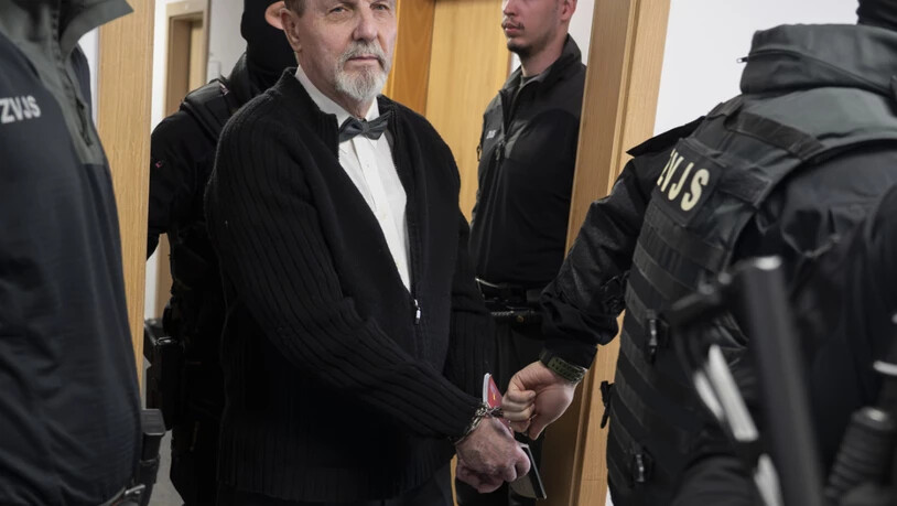 dpatopbilder - Der im Fall des Attentats auf den slowakischen Ministerpräsidenten Robert Fico Angeklagte Juraj Cintula (M) wird mit Handschellen in den Gerichtssaal des Obersten Gerichts der Slowakei geführt. Foto: Martin Baumann/TASR/dpa
