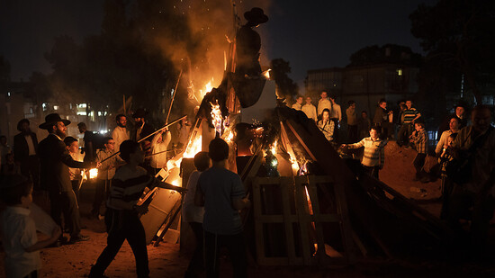 Ultraorthodoxe Juden entzünden ein Lagerfeuer während des jüdischen Feiertags Lag baOmer. Wegen Unruhen ist das zugehörige Festival frühzeitig beendet worden. Foto: Oded Balilty/AP/dpa